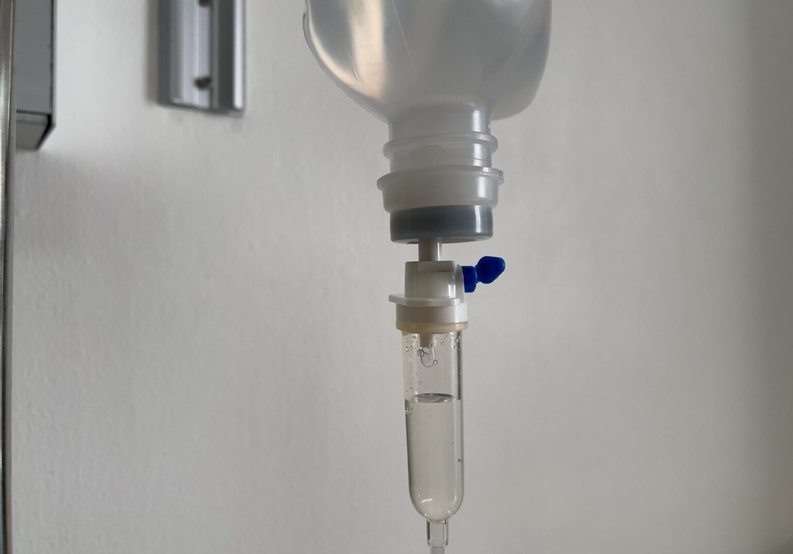 IV drip bag with clear liquid.